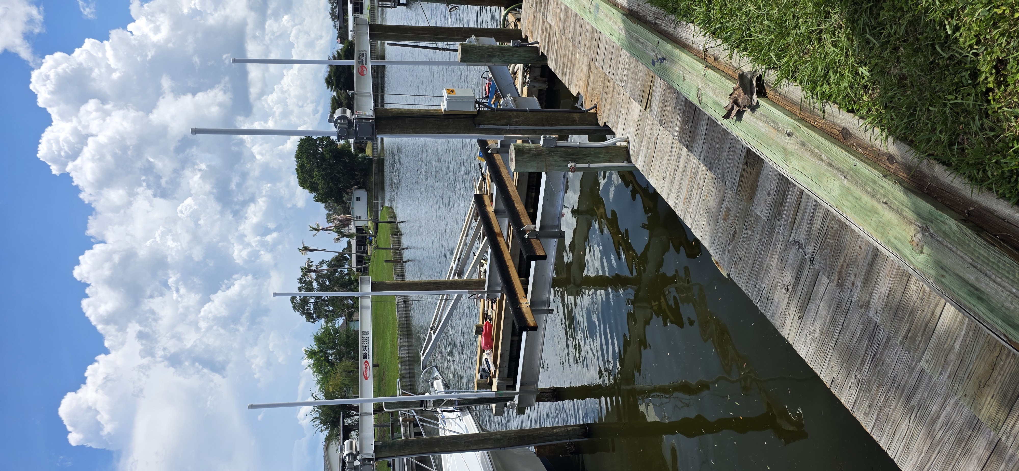 Hurricane Boat Lift frame and cradle beside a residential canal dock